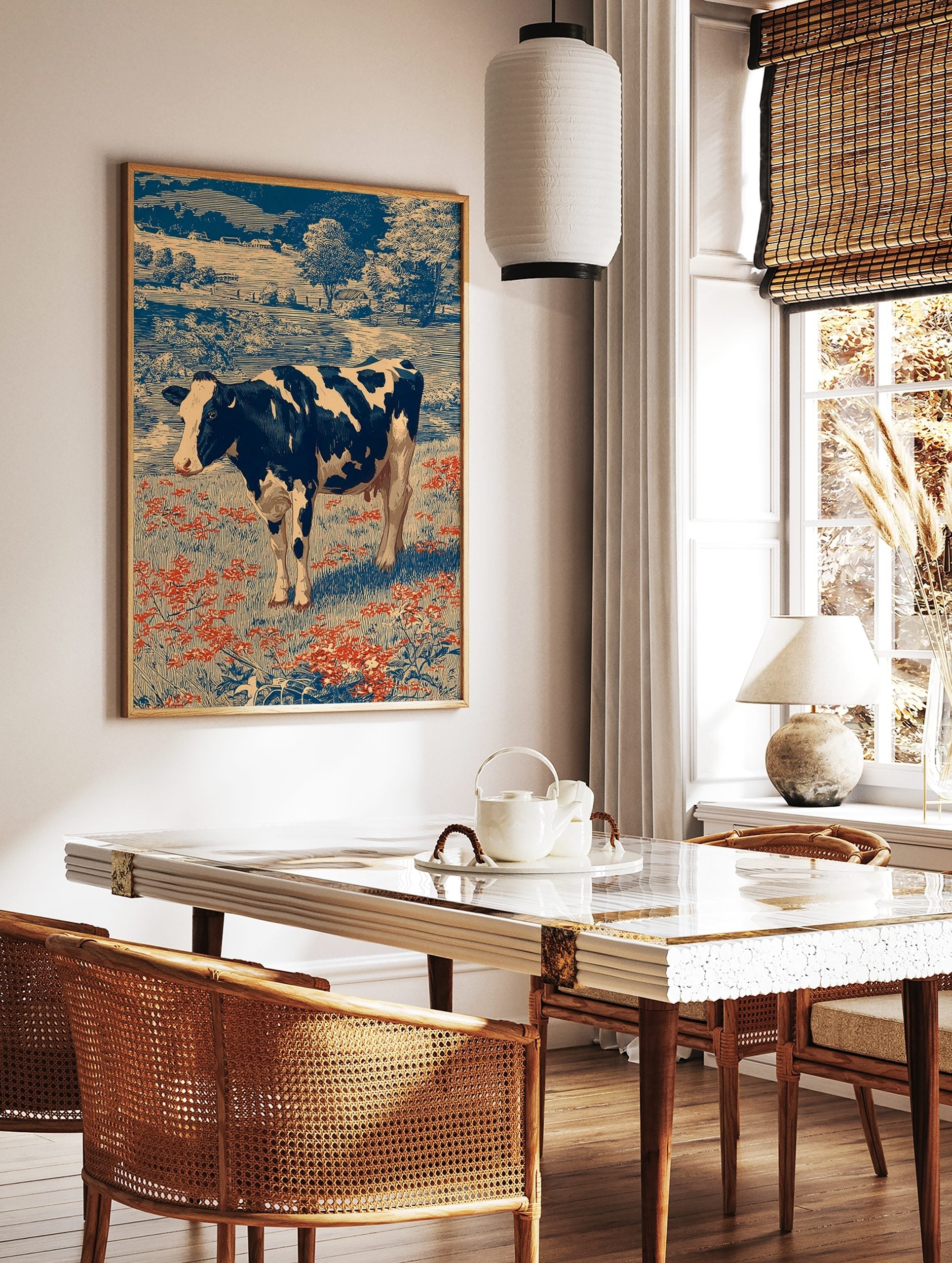 Holstein cow in a field of red flowers with blue trees and farmhouses in a vintage engraving art, in a styled room mockup