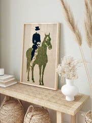 Textured dark green horse and black rider silhouette art print on a light beige background, in an alternate framed mockup