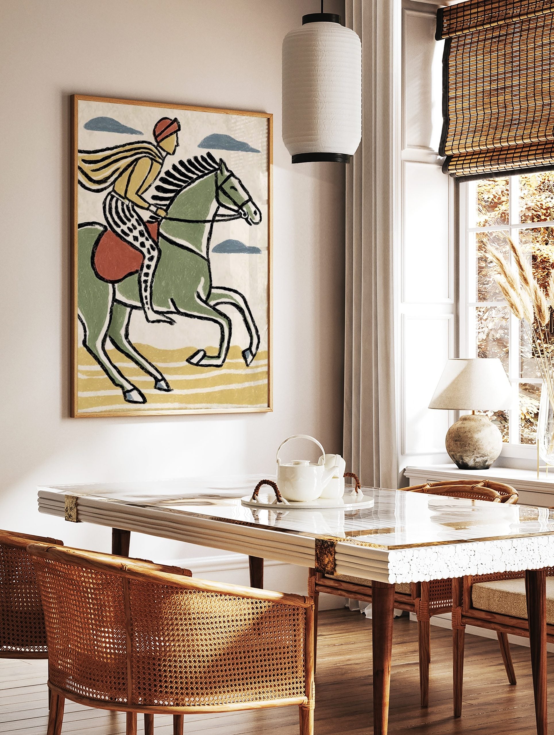 Illustrative print of a rider on a green horse with yellow cape and patterned trousers, moving right, in a styled room mockup