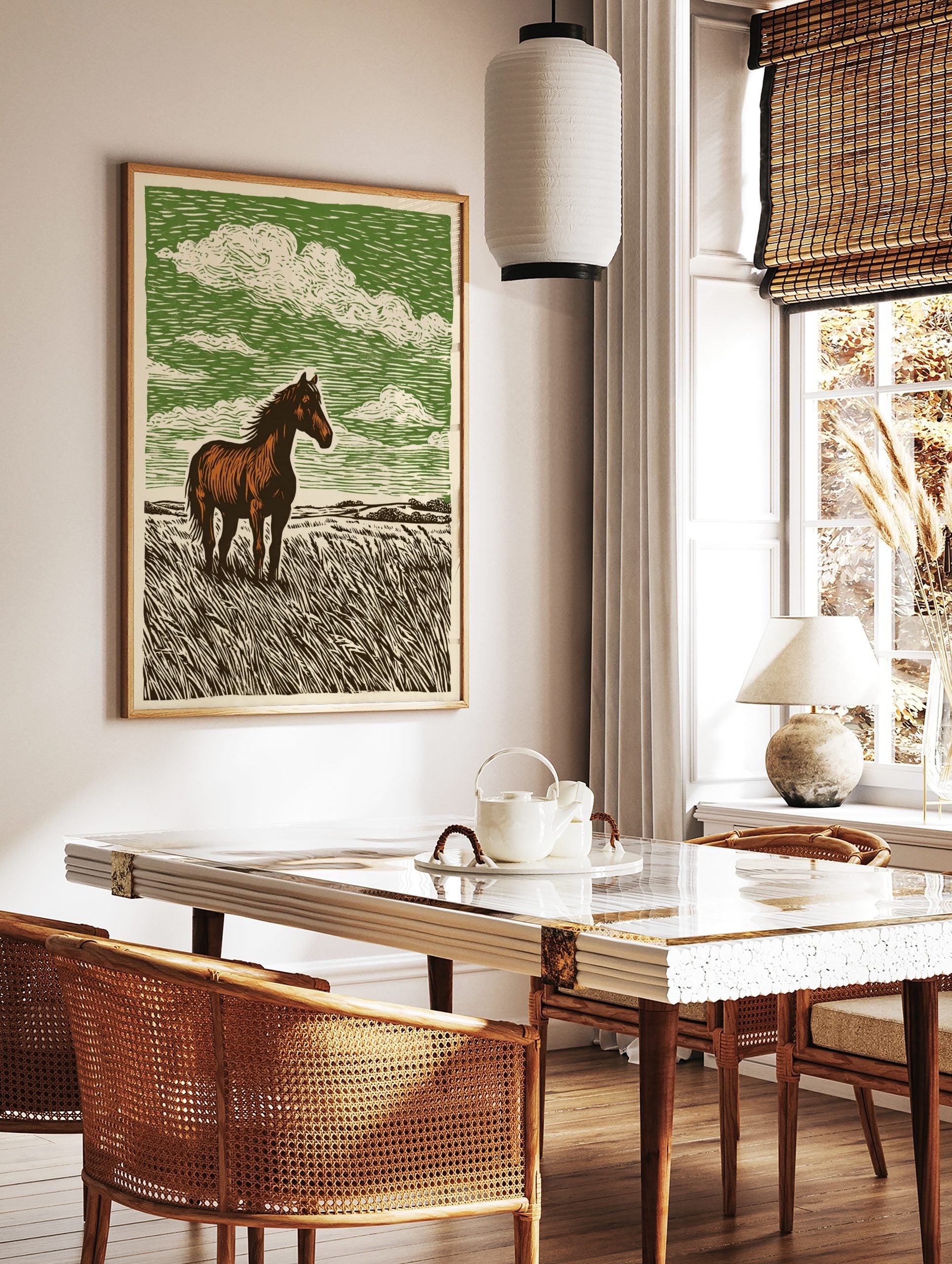 Brown horse standing in tall grass field with green sky and white clouds, linocut style art print, in a styled room mockup