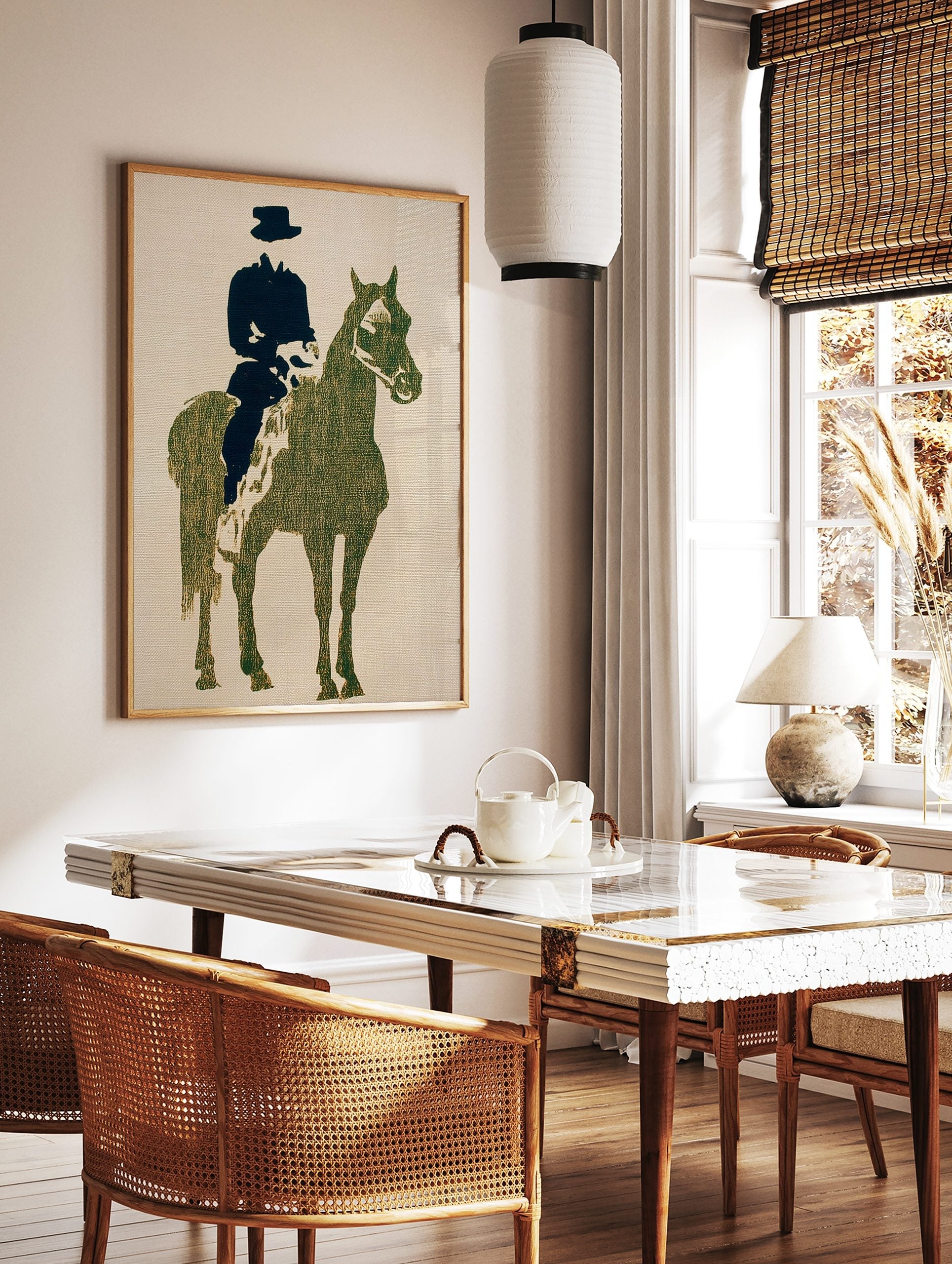 Textured olive green and black silhouette print of a horse and rider against a light, in a styled room mockup