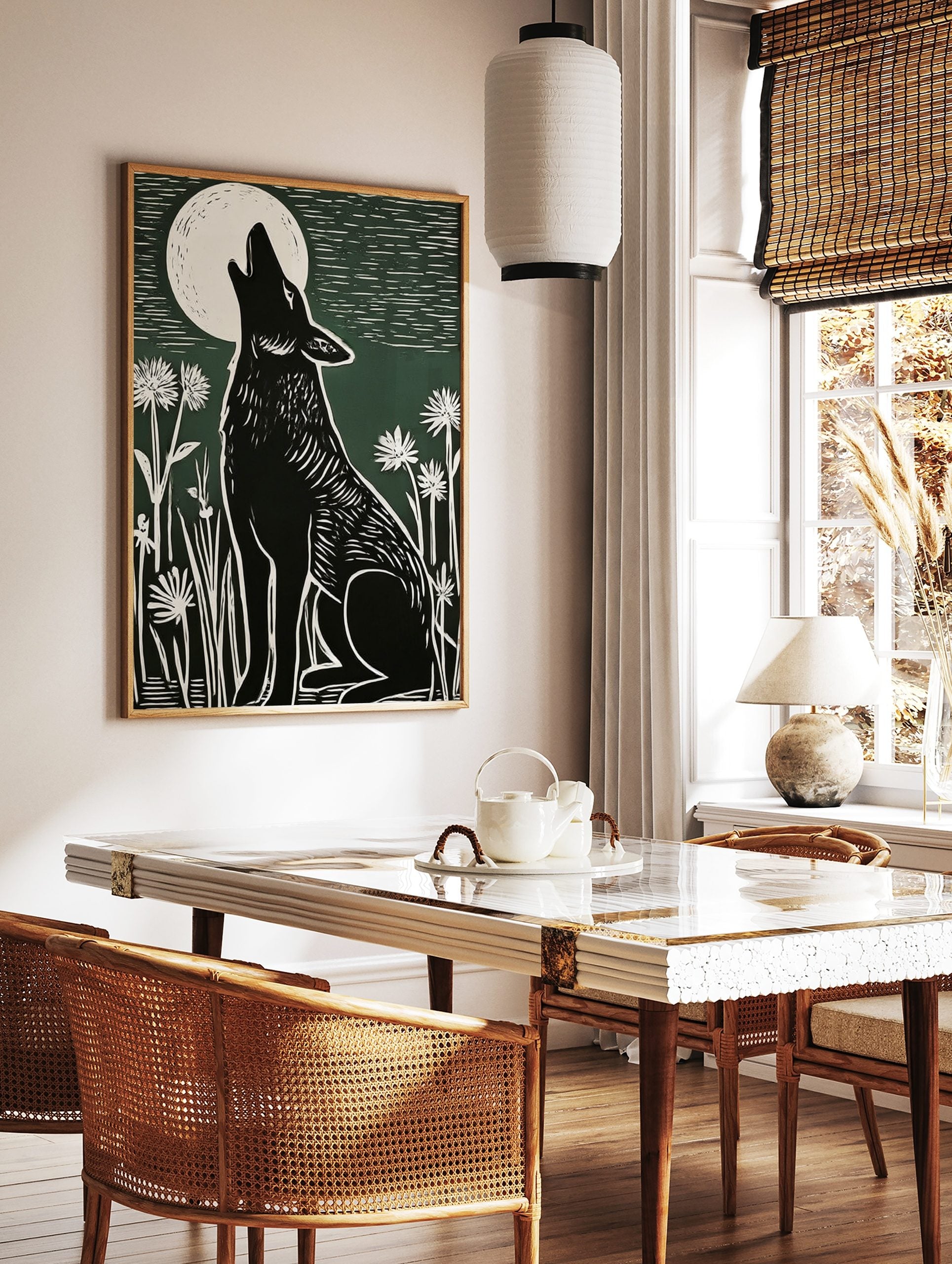 Black howling wolf linocut art print under a white full moon with white wildflowers on a green, in a styled room mockup