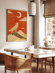 Illustrative print of a howling wolf on a hill, looking up at a crescent moon and stars against a, in a styled room mockup