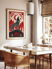 Howling wolf against red moon and stars, framed by mountains and folk art border in red, black, in a styled room mockup