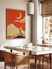 Illustrative print of a howling wolf, a large crescent moon, and a snow-capped mountain under a red, in a styled room mockup