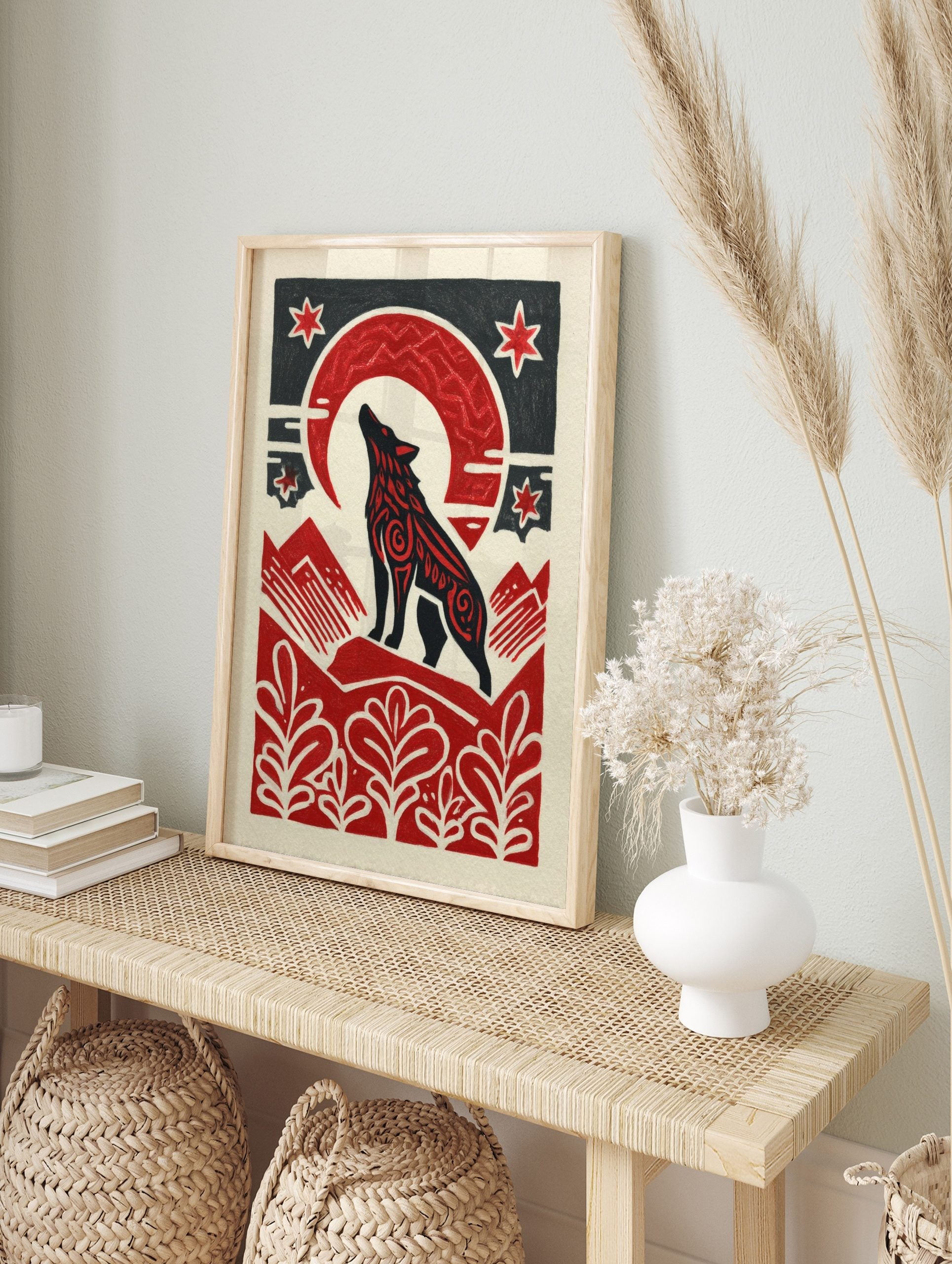 Black howling wolf with red patterns under a red crescent moon and stars, with red mountains, in an alternate framed mockup