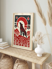 Black howling wolf with red patterns under a red crescent moon and stars, with red mountains, in an alternate framed mockup