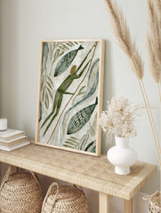 Primitive style hunter with spear and two striped fish, surrounded by green leaves and, in an alternate framed mockup