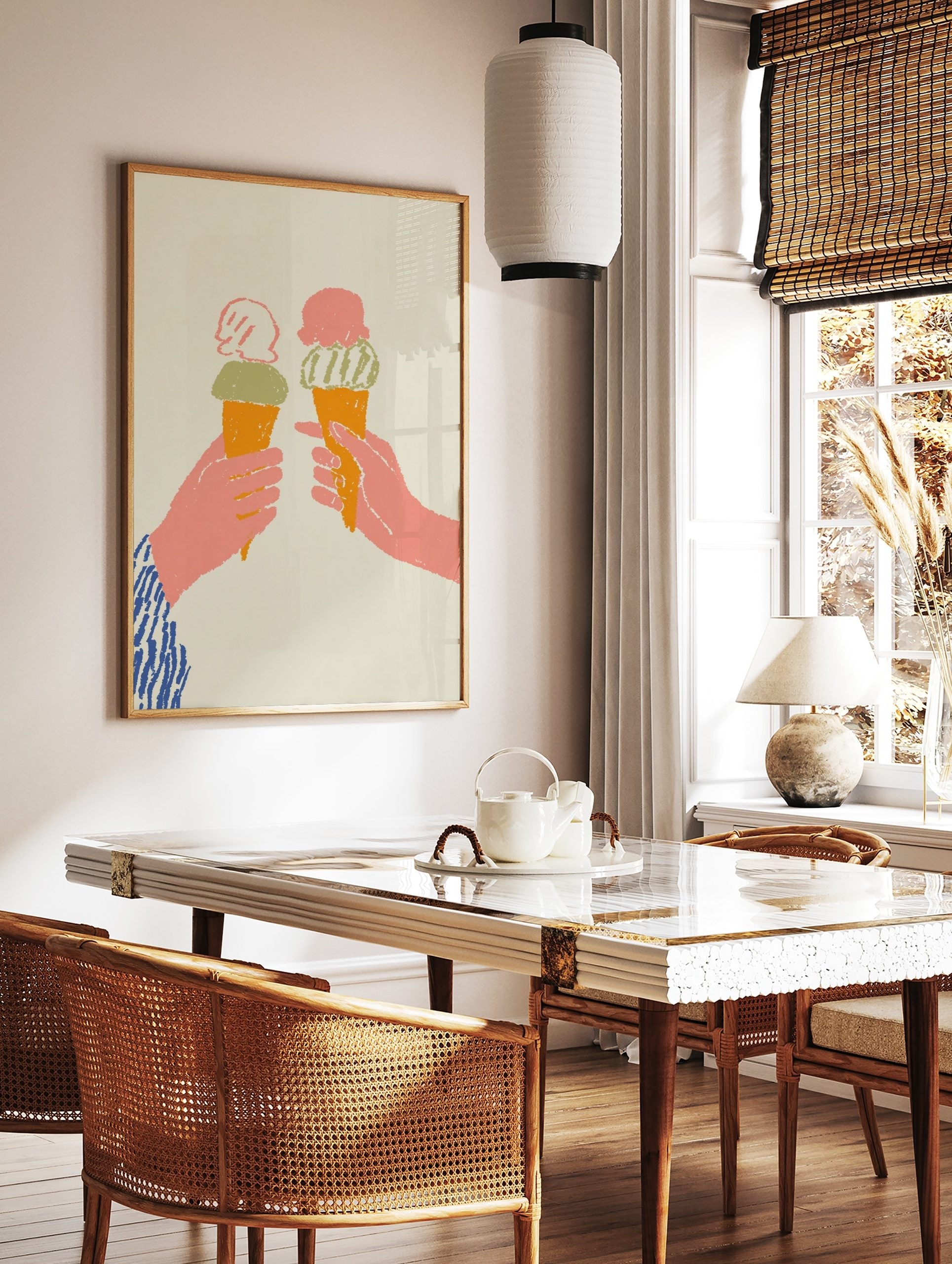 Two hands holding orange ice cream cones with pink and green scoops, on a light beige background in, in a styled room mockup