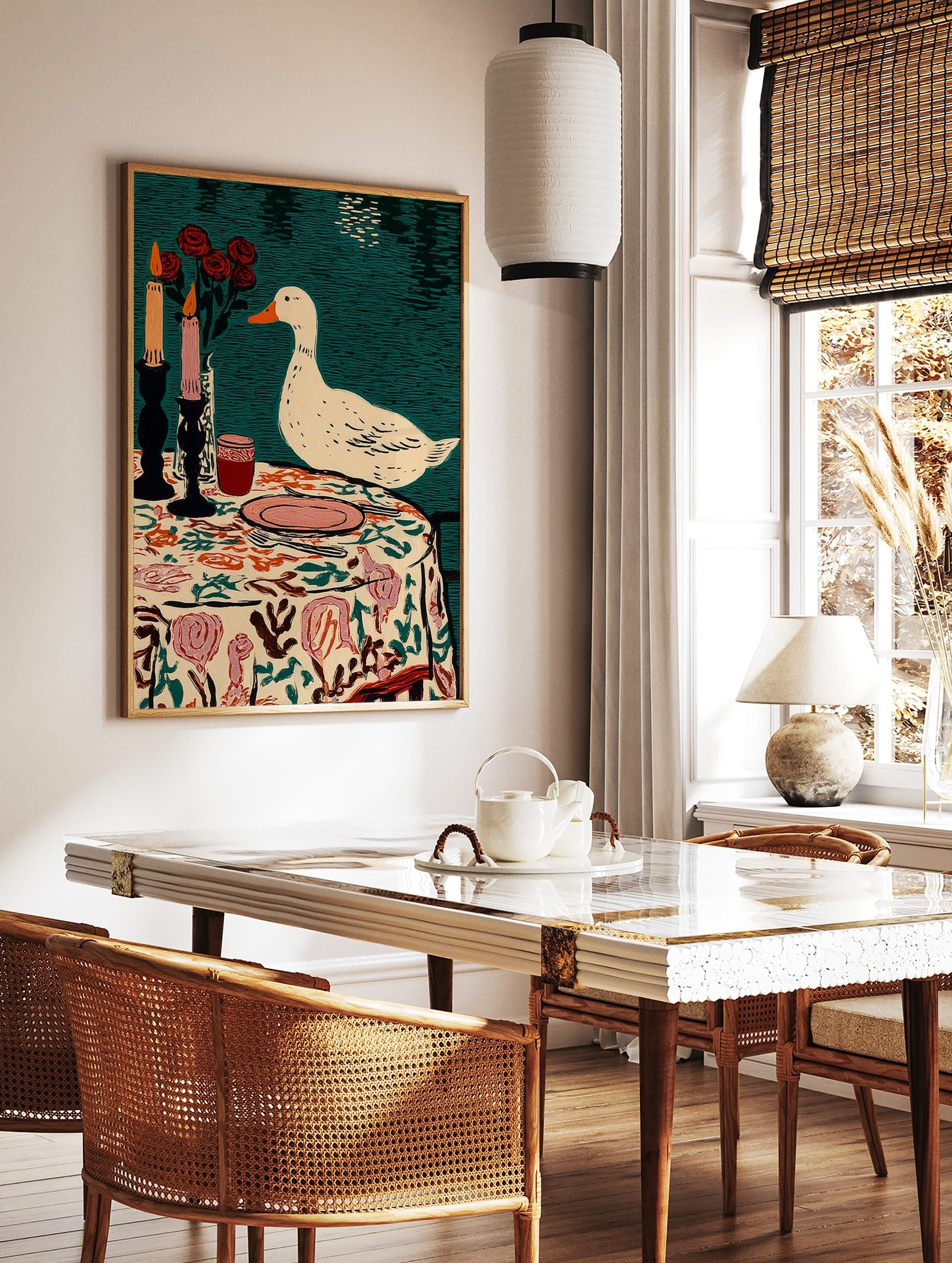Illustrative print of a white duck observing a table setting with candles, red roses, and a floral, in a styled room mockup