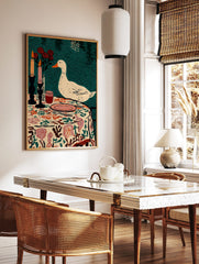 Illustrative print of a white duck observing a table setting with candles, red roses, and a floral, in a styled room mockup