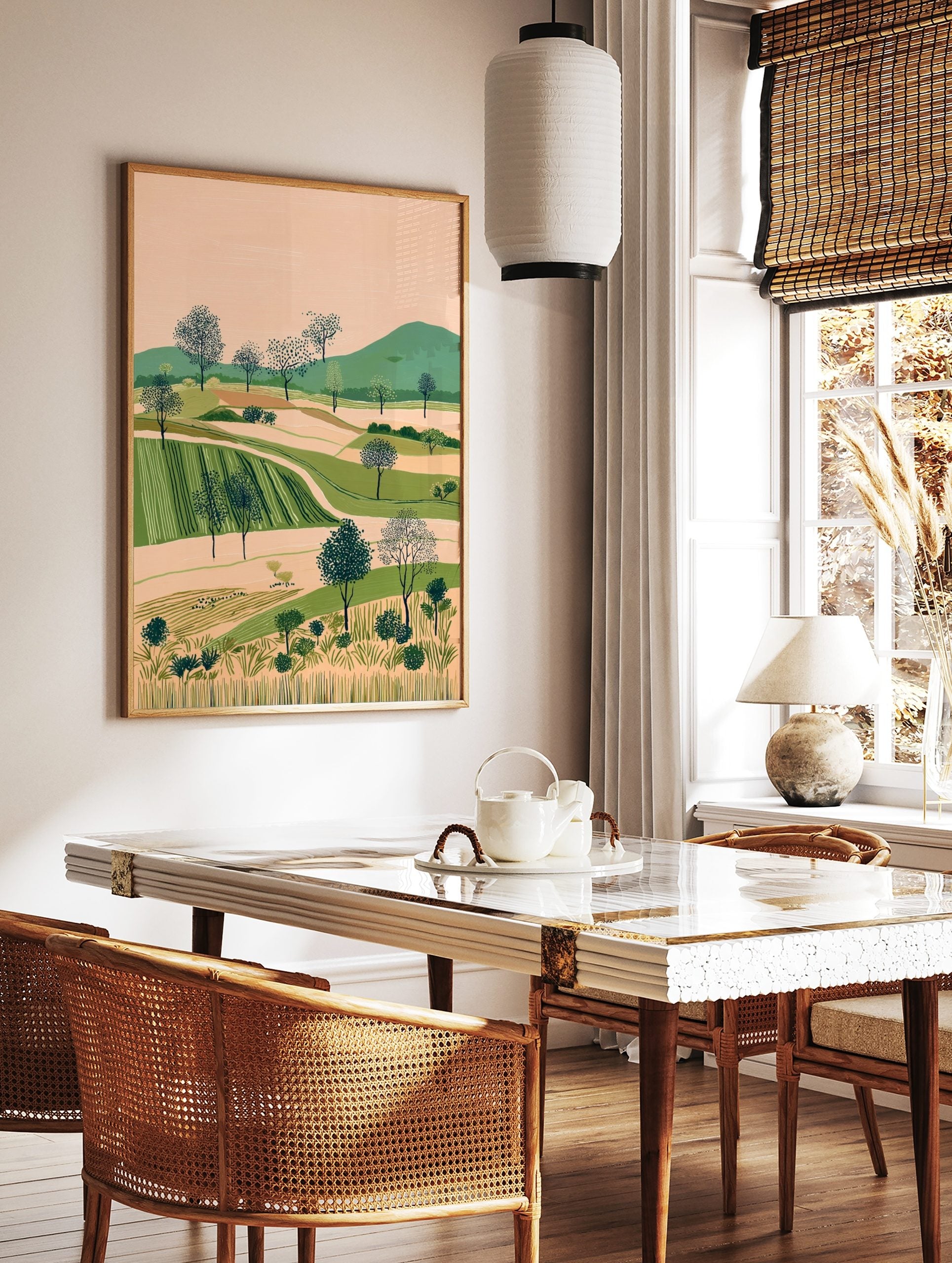 Illustrative landscape art print with rolling green hills, cultivated fields, and dotted trees, in a styled room mockup