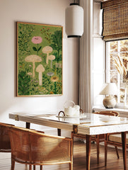 Illustrative mushroom and botanical wall art print with pink flower, beige mushrooms, and green, in a styled room mockup