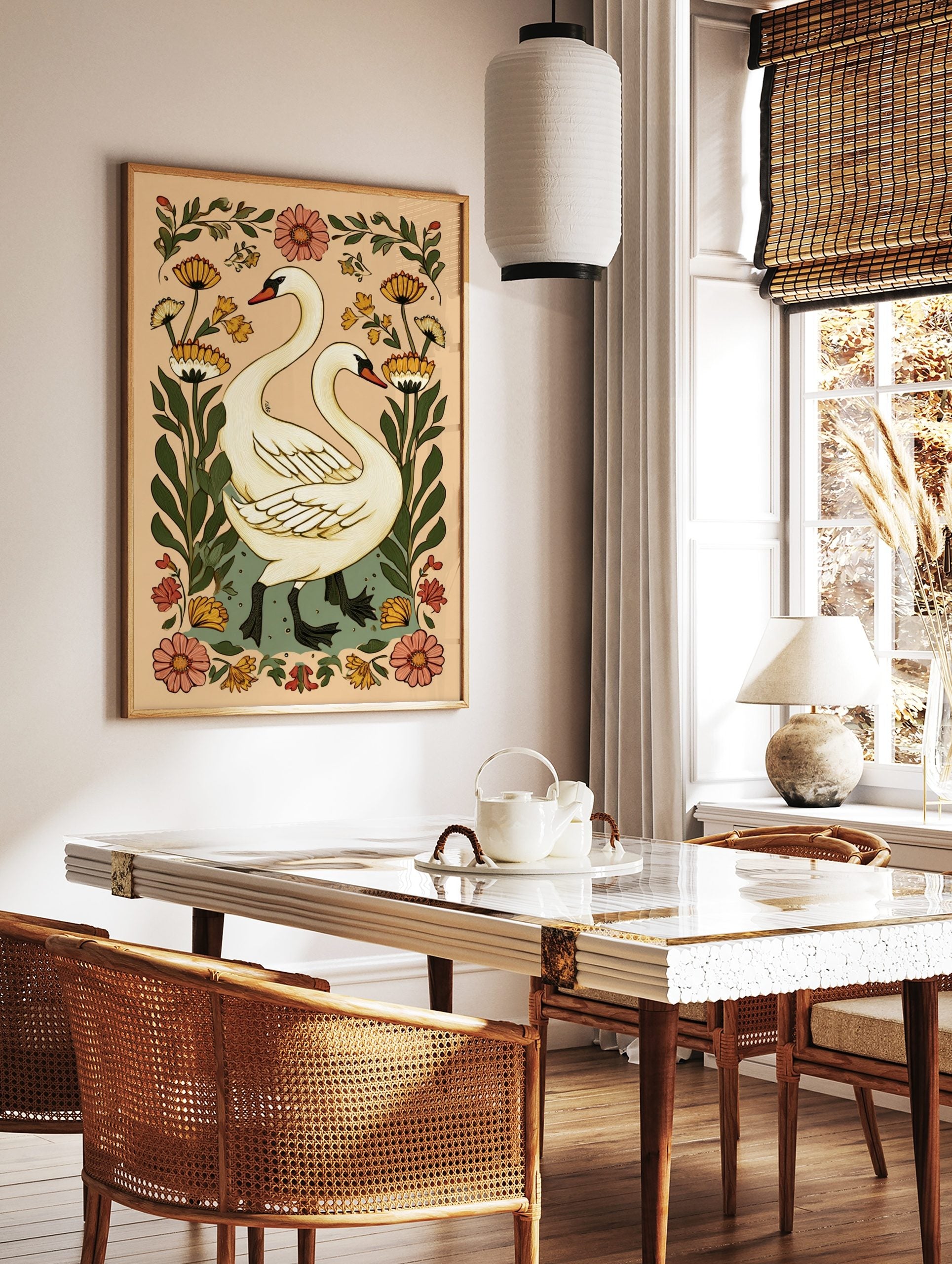 Illustrative white swans with long necks and black webbed feet, surrounded by orange and pink, in a styled room mockup