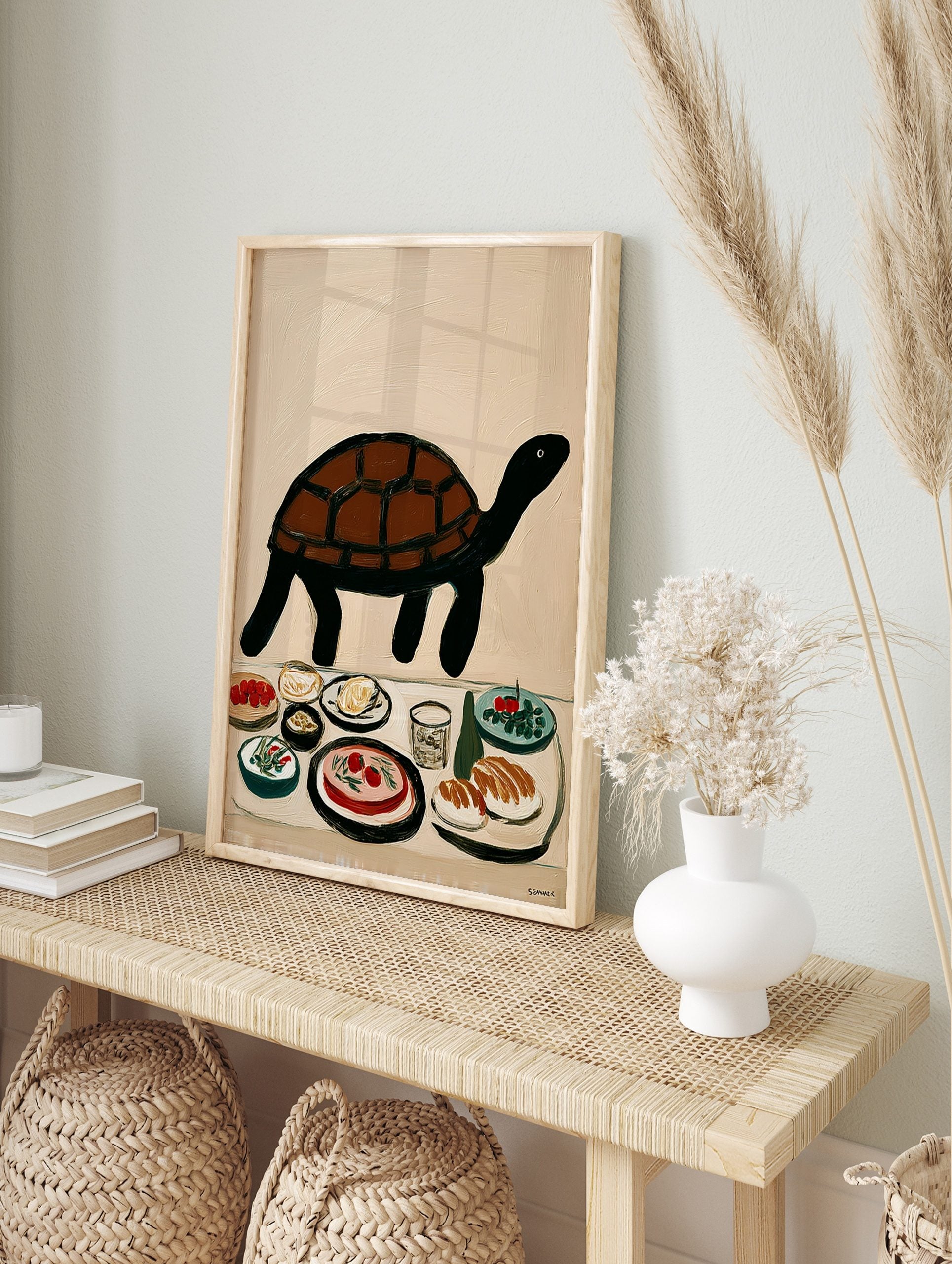 Illustrative brown and black turtle above a table with various food dishes and a glass on a, in an alternate framed mockup