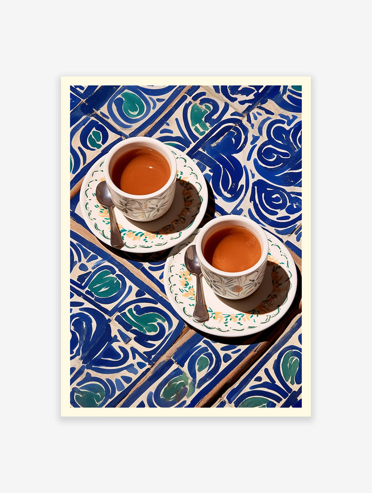 Two cups of coffee with spoons on a blue and white patterned tile surface.