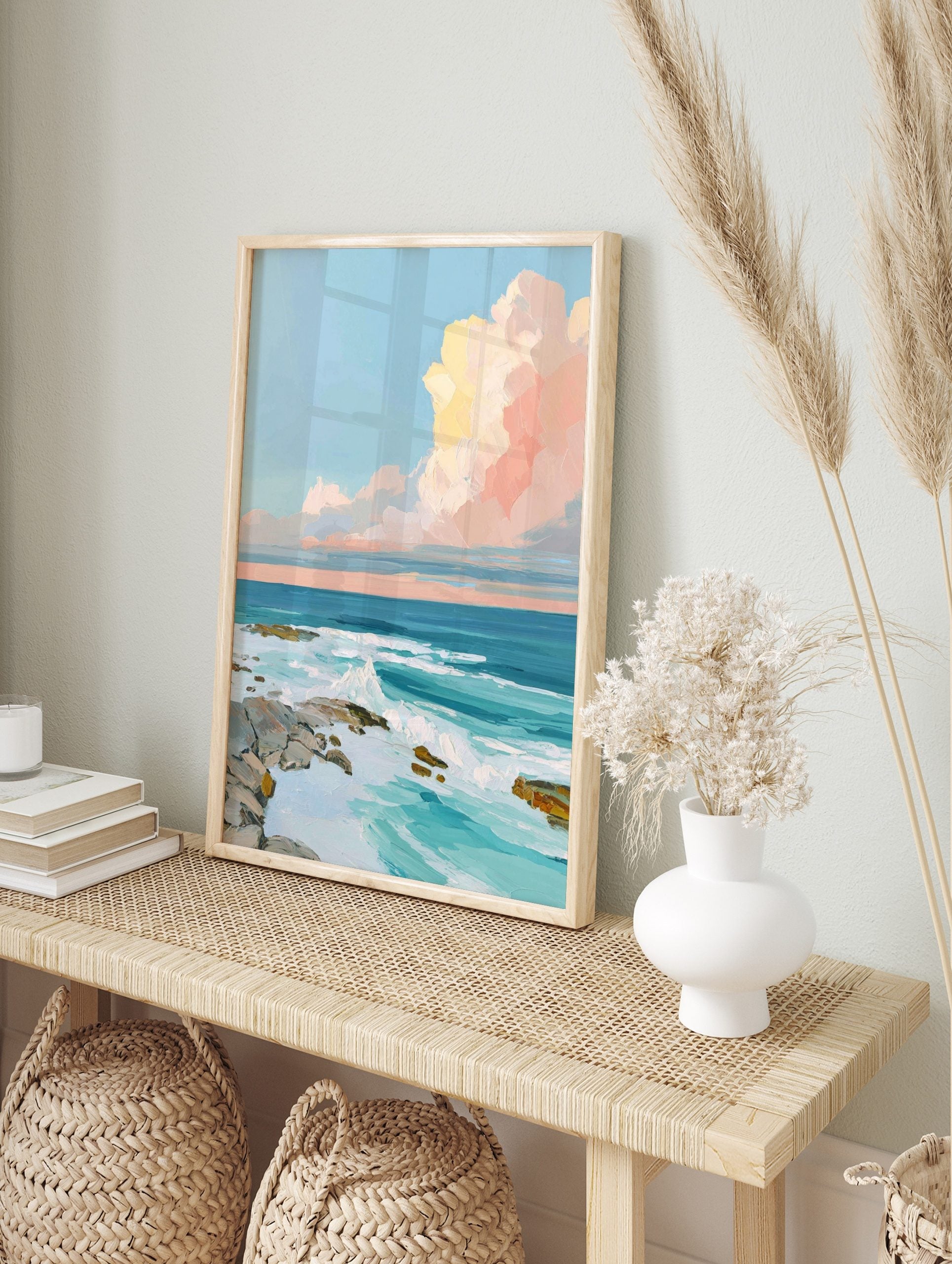 Impressionistic ocean wall art with crashing waves, rocky shore, and pastel pink and yellow, in an alternate framed mockup
