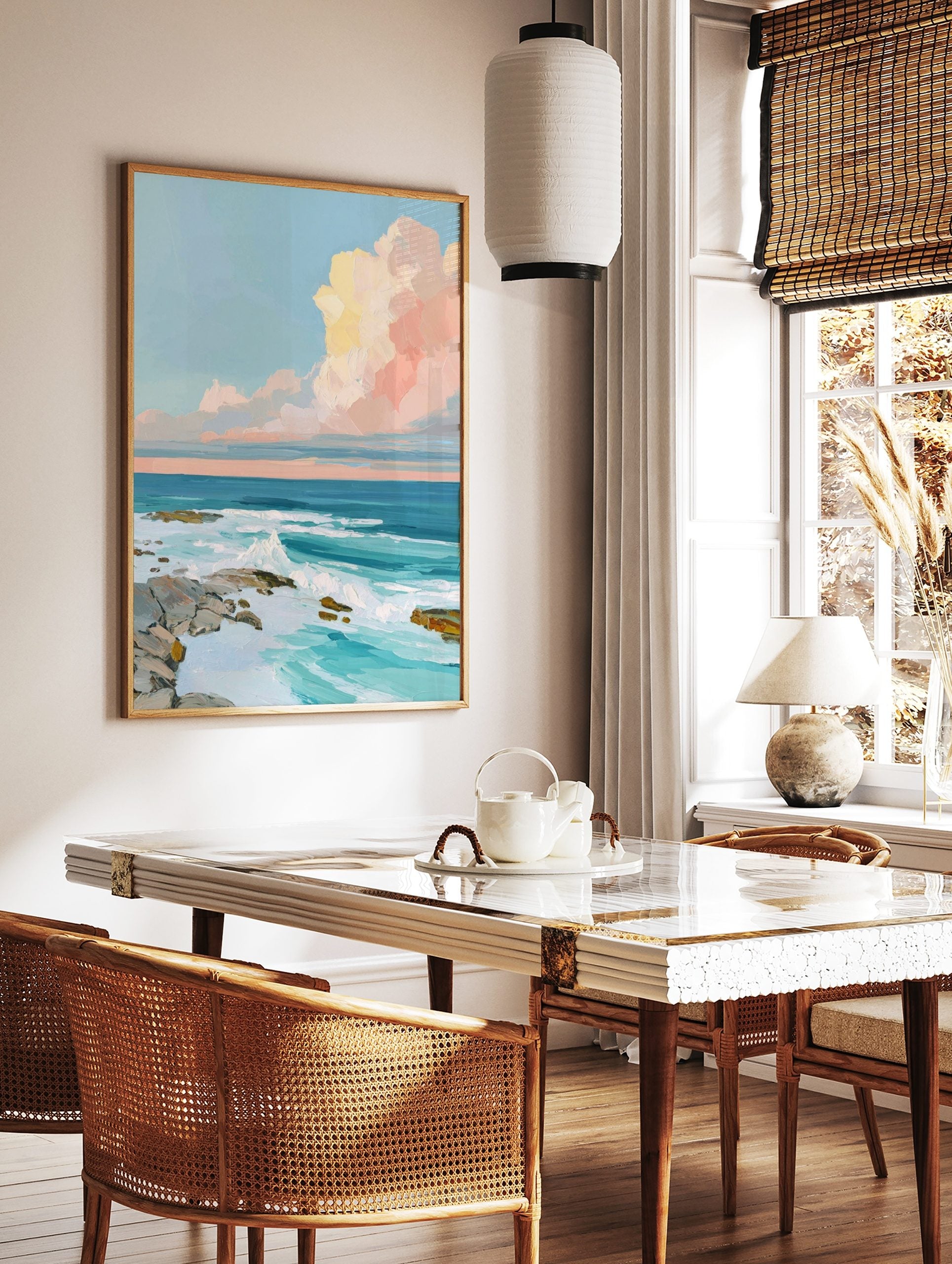 Impressionistic ocean wall art with crashing waves, rocky shore, and pastel pink and yellow clouds, in a styled room mockup