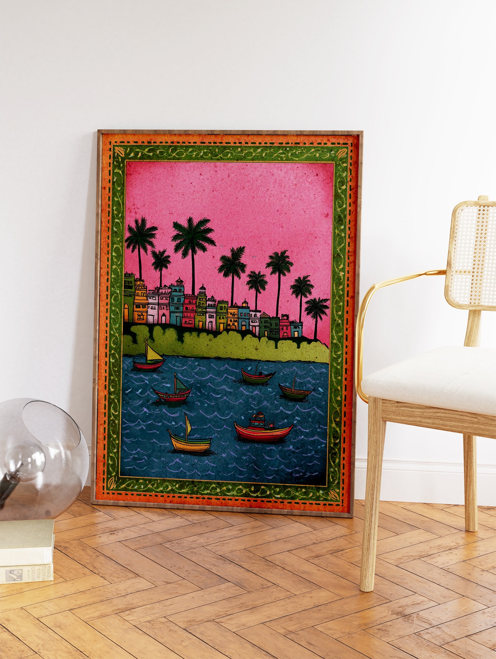 Colorful Indian cityscape wall art with buildings, palm trees, and boats on blue water under a pink sky, ornate border. - Image 2