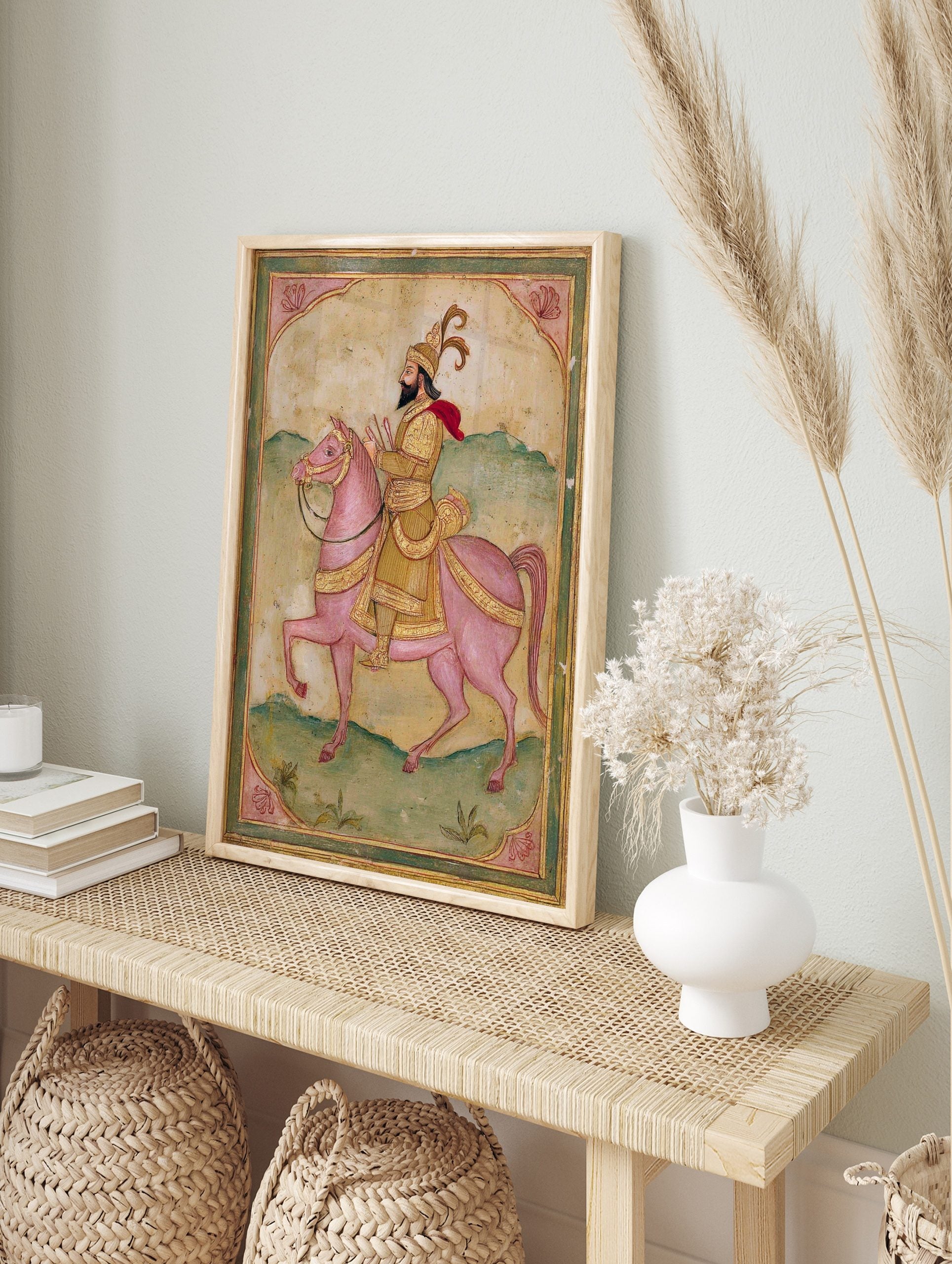 Indian miniature art print of bearded rider in golden attire and red cape on a pink horse, in an alternate framed mockup
