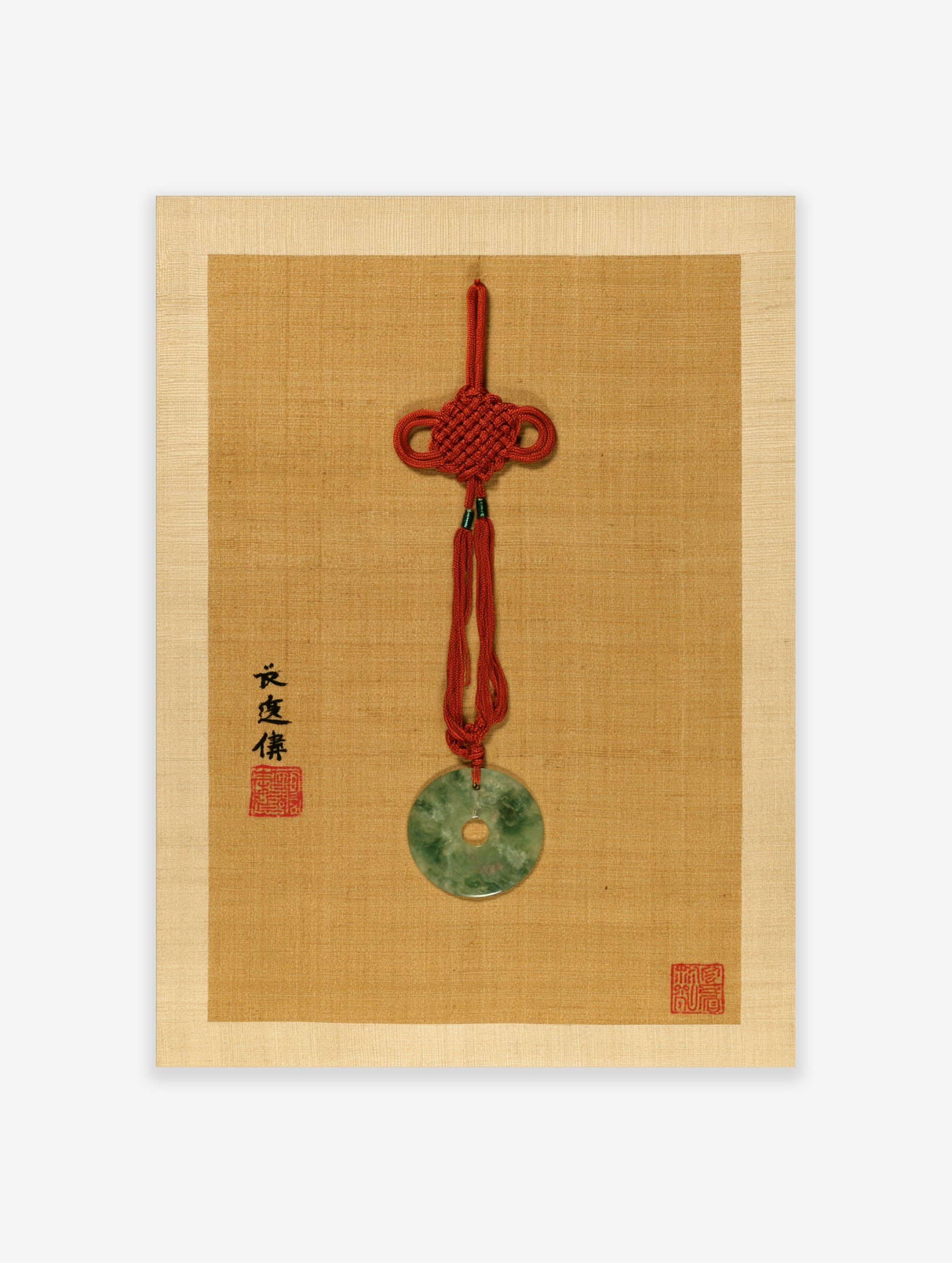 Jade bi pendant with red knot and calligraphy on tan textured background