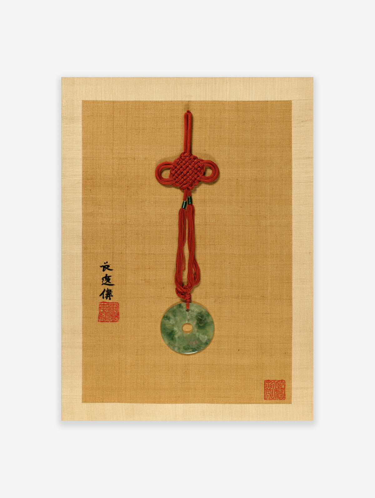 Jade bi pendant with red knot and calligraphy on tan textured background