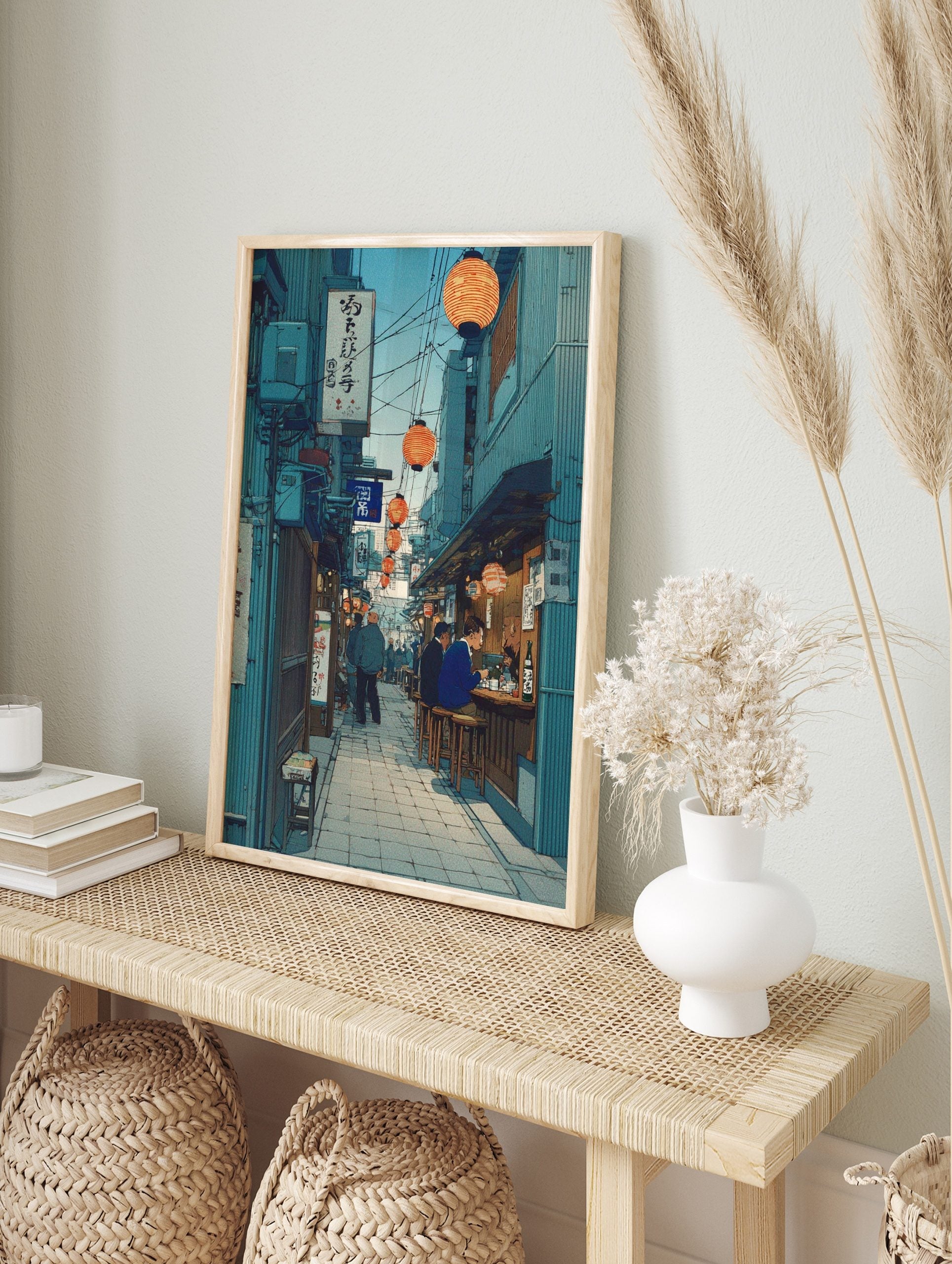 Japanese alleyway wall art with orange lanterns, street food stalls, people dining, and teal, in an alternate framed mockup