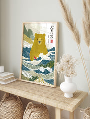Illustrative Japanese bear standing in blue river holding a red fish, with green hills and, in an alternate framed mockup