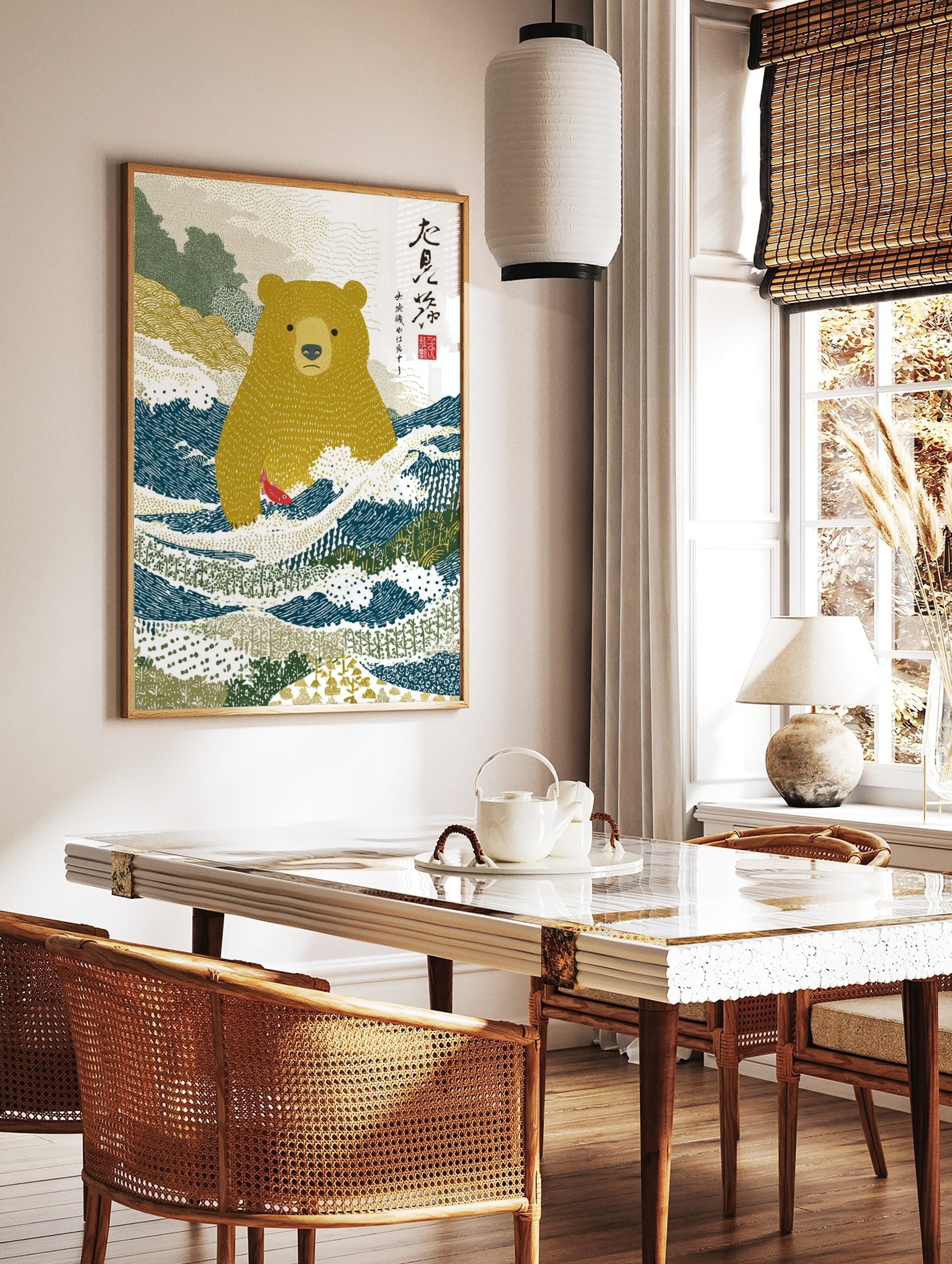 Illustrative Japanese bear standing in blue river holding a red fish, with green hills and text, in a styled room mockup