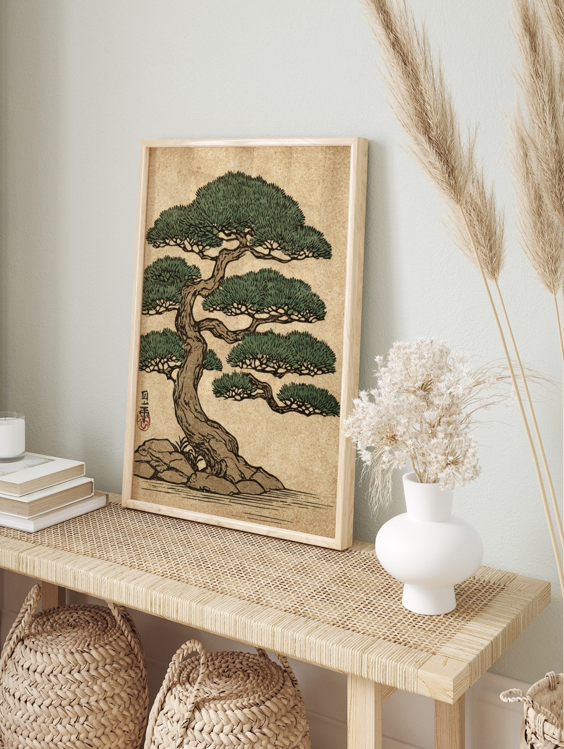 Japanese bonsai pine tree art print with green foliage, brown trunk, rocks, and water in an, in an alternate framed mockup