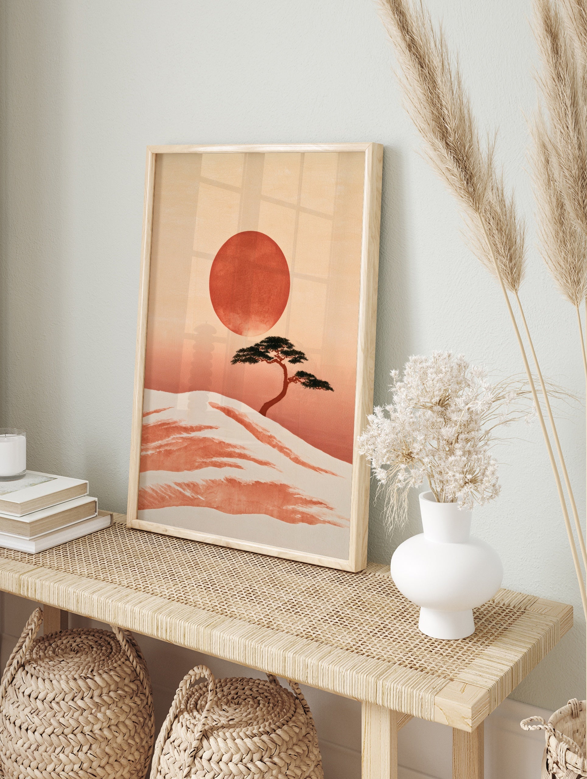 Minimalist Japanese landscape print featuring a bonsai tree on a sandy dune with a large red, in an alternate framed mockup
