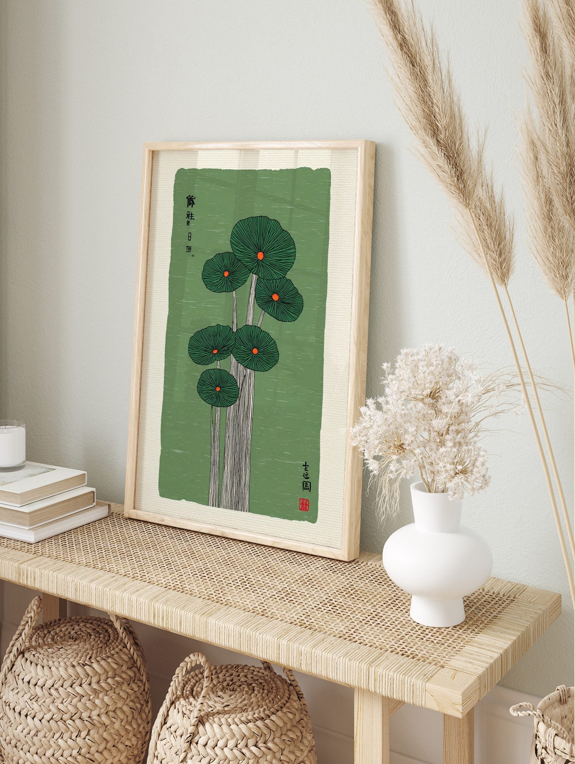 Japanese botanical print of five green lotus leaves with orange centres on a textured green, in an alternate framed mockup