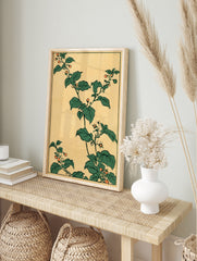 Japanese botanical art print featuring green leaves and orange berries on a tan background, in an alternate framed mockup