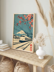 Japanese bullet train with Mount Fuji and red cherry blossoms, railway tracks, blue sky, in an alternate framed mockup
