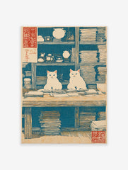 Japanese woodblock print of two white cats sitting at a desk with books and tea ware, blue background.