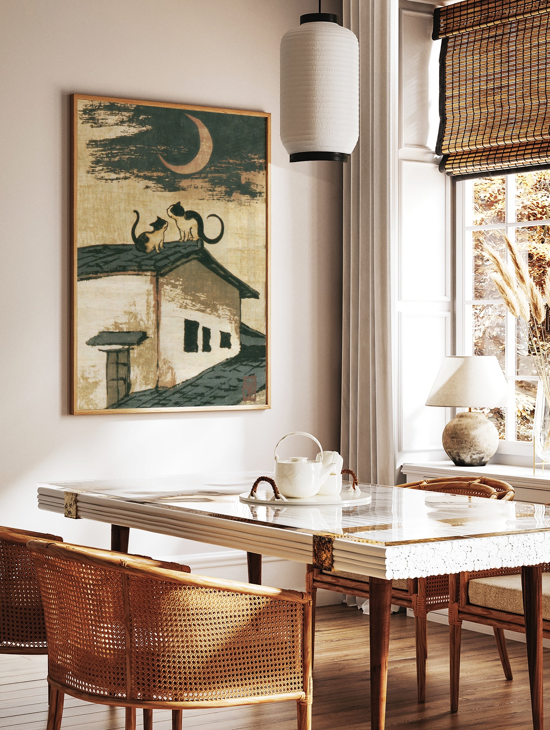 Japanese-style illustration of two cats sitting on a tiled roof beneath a crescent moon, in a styled room mockup