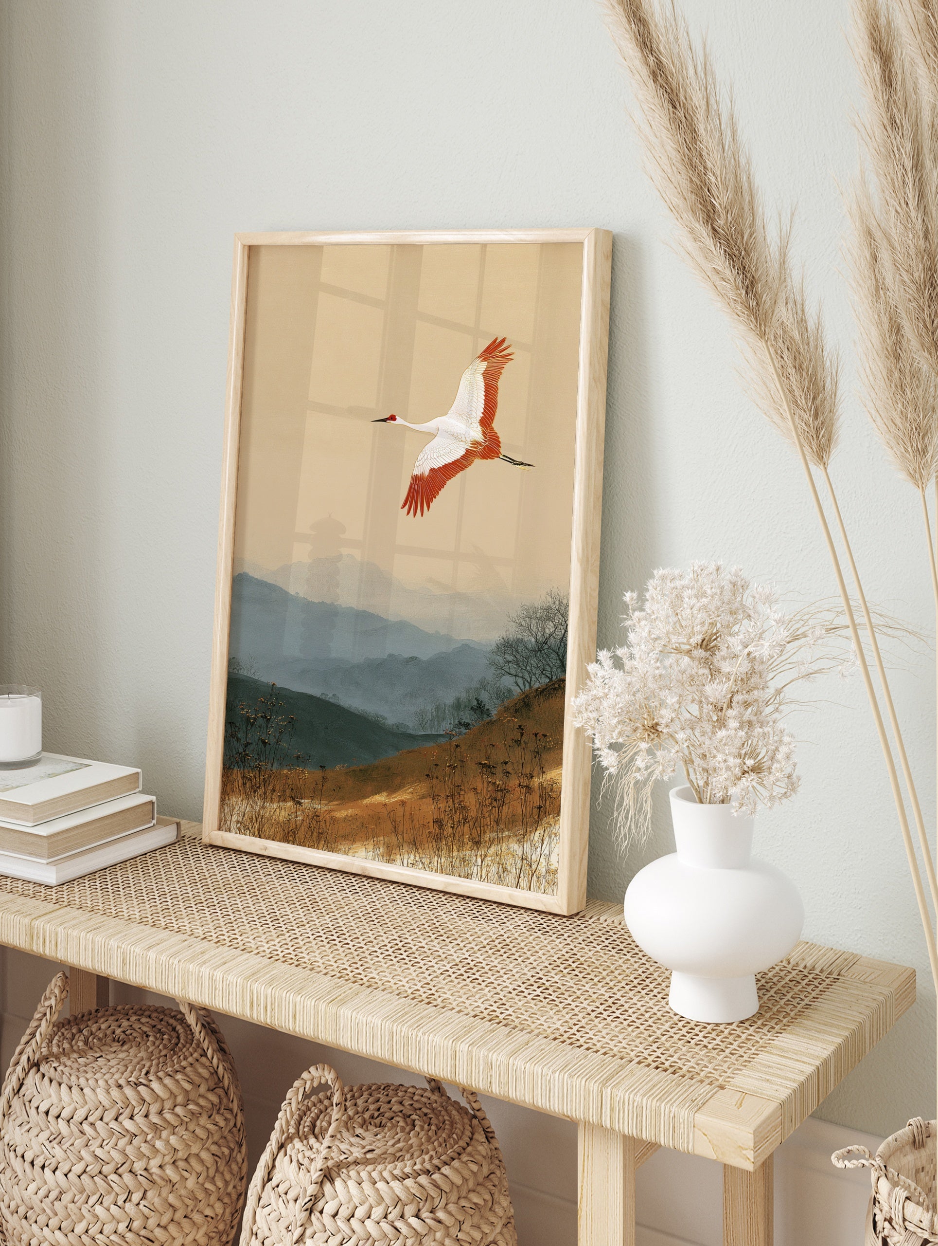 Japanese red-crowned crane flying over misty blue mountains and earthy grass landscape art, in an alternate framed mockup