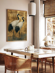 Illustrative Japanese crane wall art featuring two white and black cranes with red crowns on a gold, in a styled room mockup