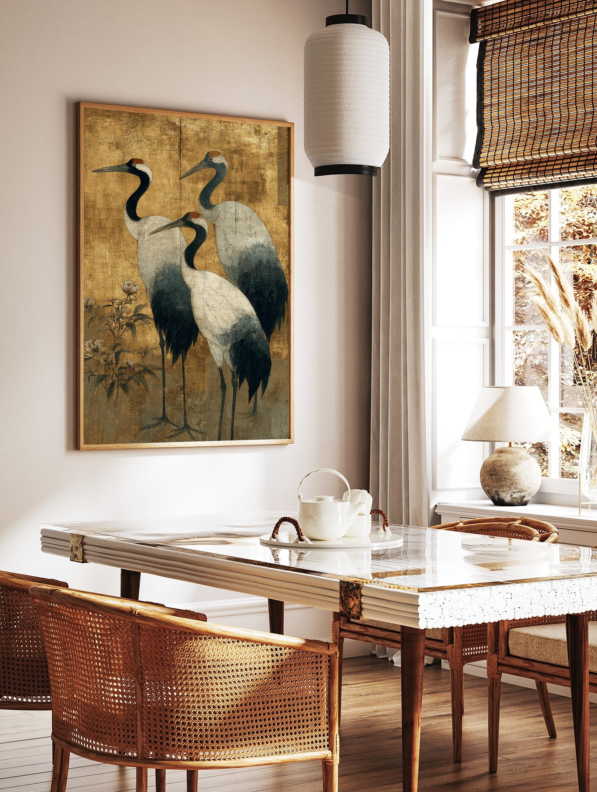 Japanese art print of three red-crowned cranes with black necks and white bodies on a textured gold, in a styled room mockup