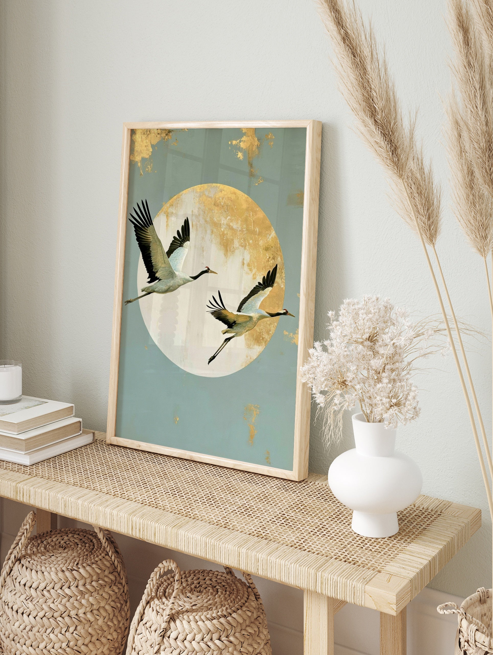Japanese crane wall art with two birds in flight against a large textured gold sun on a pale, in an alternate framed mockup