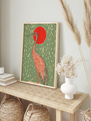 Illustrative Japanese crane with red sun and white rain on sage green background, portrait, in an alternate framed mockup