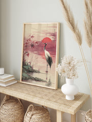 Japanese Red-crowned Crane Wall Art in water at sunset with a red sun, reeds, and rocks in a traditional watercolor style. - Image 3