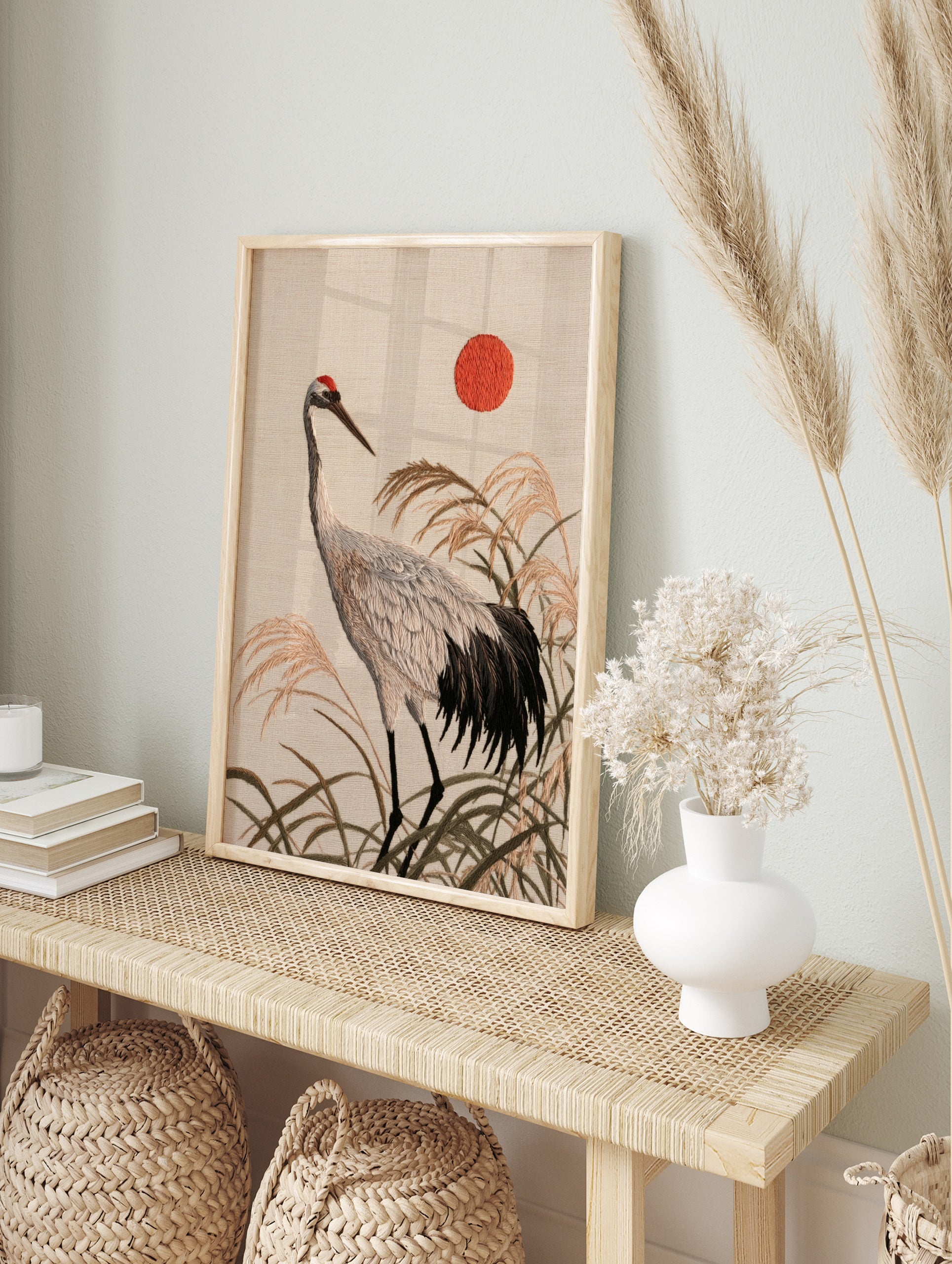 Japanese red-crowned crane illustration with tall reeds and a red sun, textured, in an alternate framed mockup