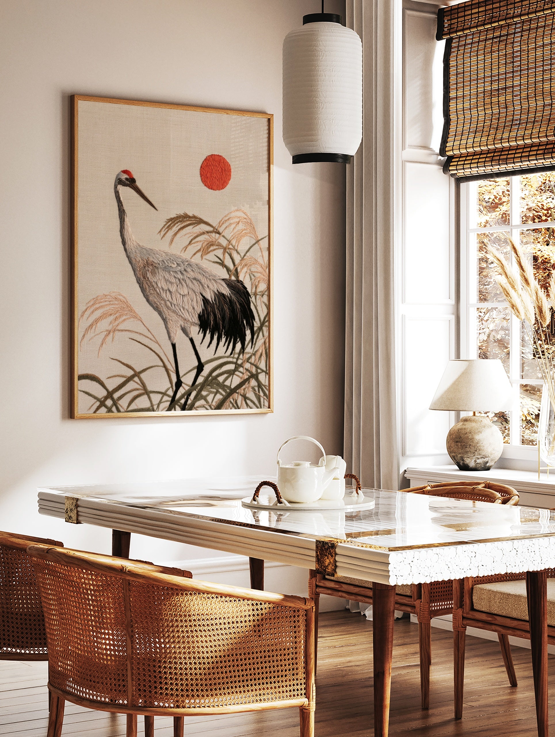 Japanese red-crowned crane illustration with tall reeds and a red sun, textured embroidery-style, in a styled room mockup