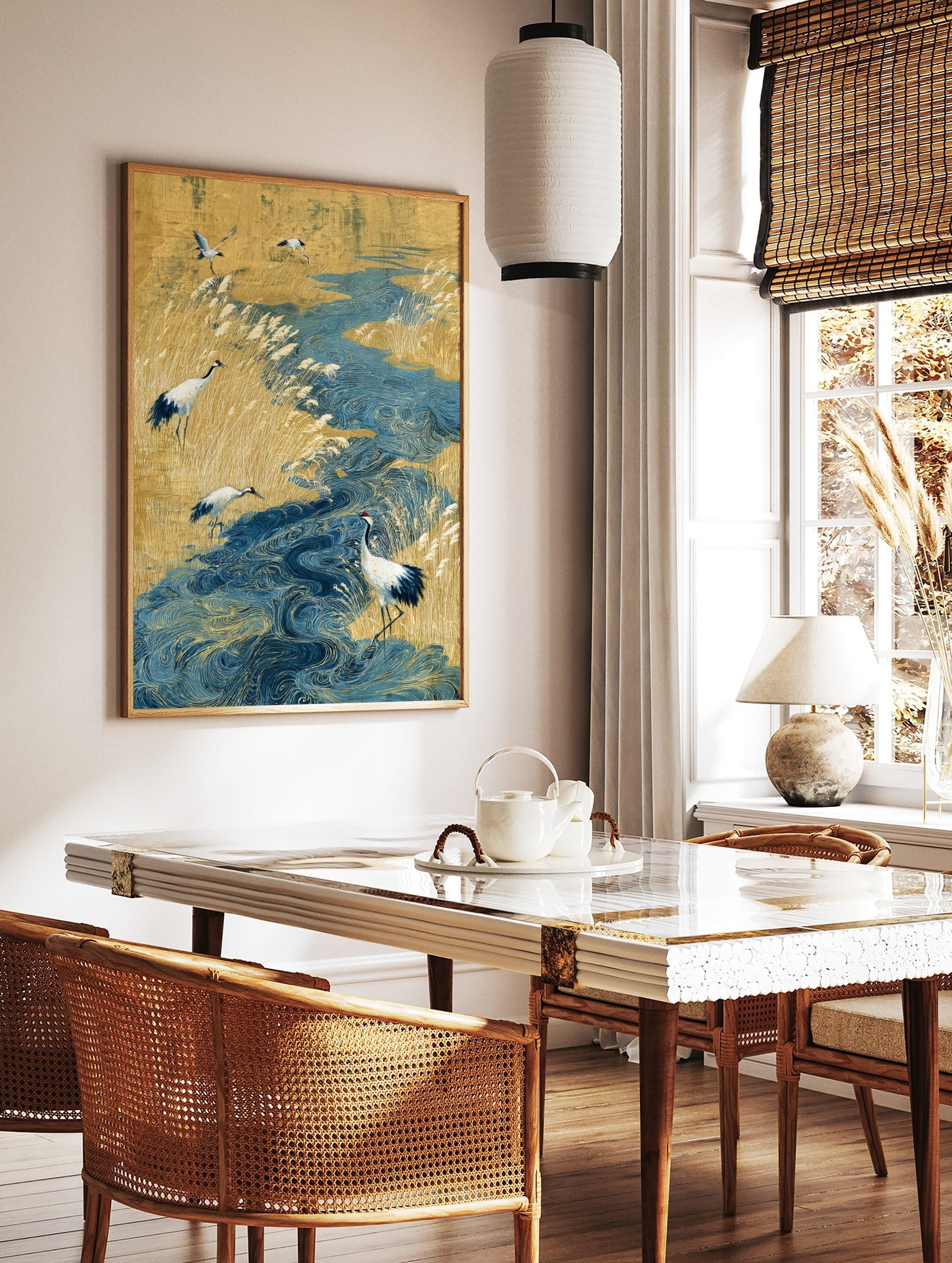 Japanese art print of red-crowned cranes in a golden reed field with a swirling blue river, in a styled room mockup