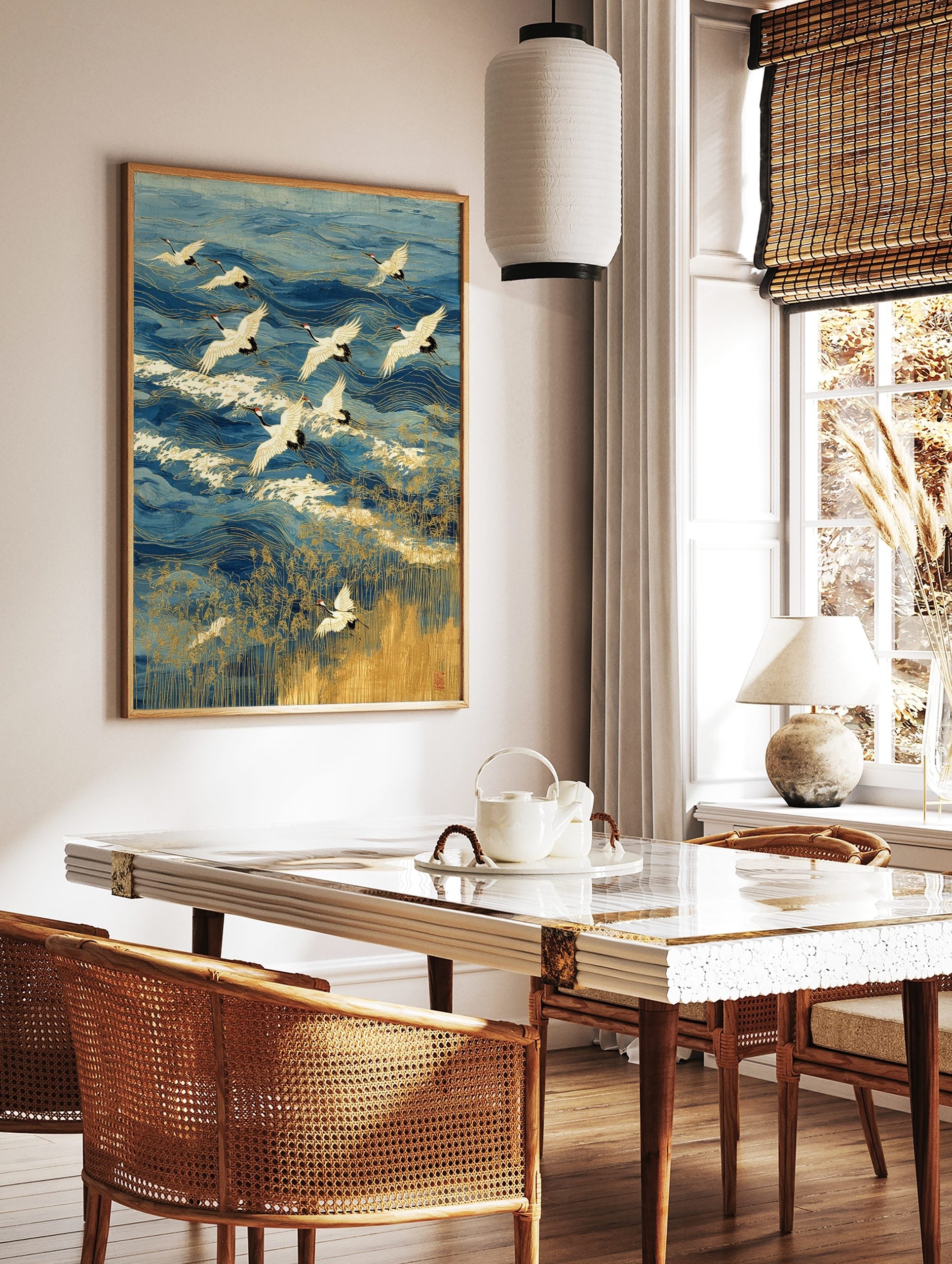 Japanese Red-crowned cranes flying over blue ocean waves with gold outlines and golden reeds, in a styled room mockup