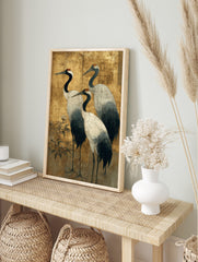 Three Japanese red-crowned cranes with white bodies and black necks on a distressed gold leaf, in an alternate framed mockup