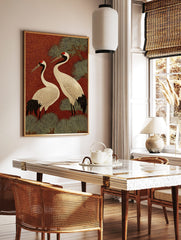 Two Japanese Red-crowned Cranes with black and white plumage, red crowns, against a red swirling, in a styled room mockup
