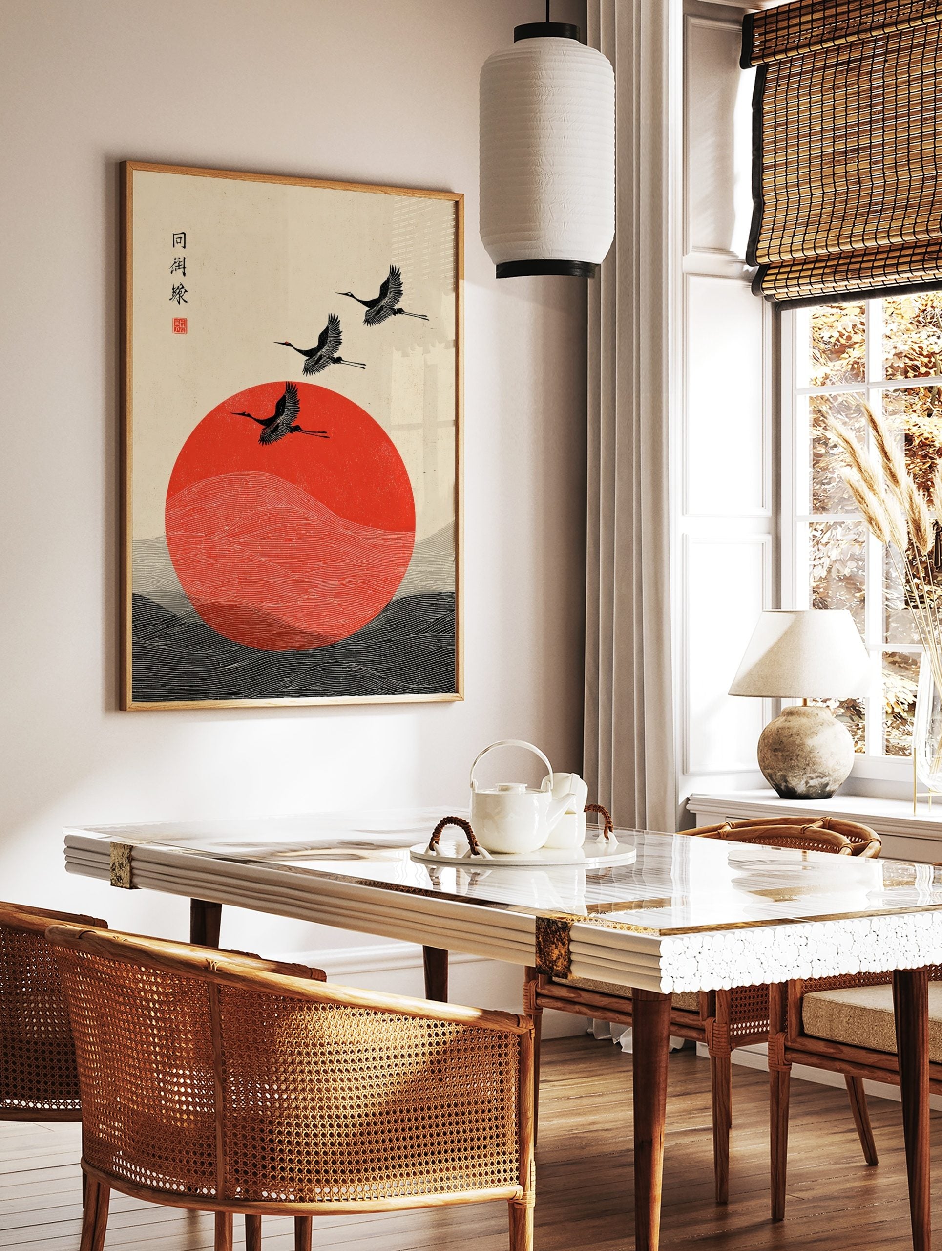 Japanese crane wall art with three black birds flying over a red sun and stylised waves, in a styled room mockup