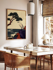 Japanese egret stands on a purple and red rocky cliff with a pine tree and dark blue sea, in a styled room mockup